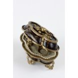Miniature ovoid casket in tortoise shell with a poly-lobbed frame. Golden metal structure. The