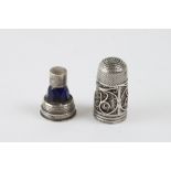 Filigreed silver thimble screwed on a silver base. It contains a small perfume bottle in midnight