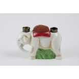 Porcelain elephant with a double thimble holder and a needle and pin cushion. H: 8cm, L: 11cm, W: