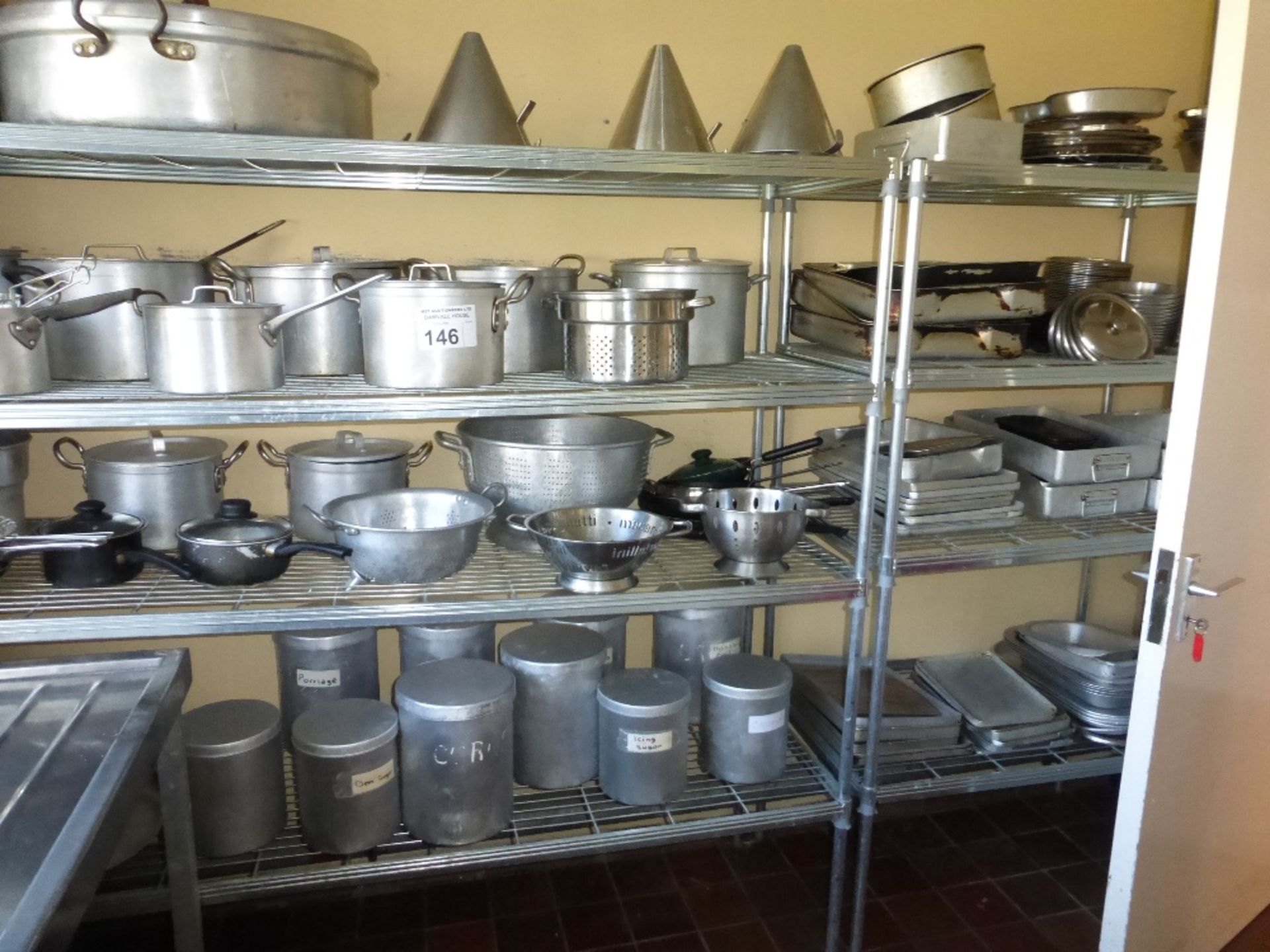 3 metal four tier racks and a large quantity of miscellaneous aluminium pans, colanders, bins and