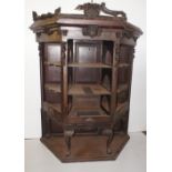 NV- A carved hardwood open fronted, three sided display cabinet with shelves on cabriole legs