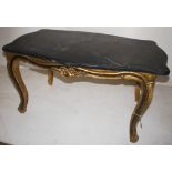 NV- A black rectangular marble top coffee table with a gilt work base