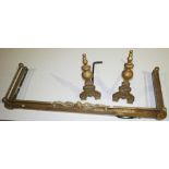 NV- A decorative brass fire curb, a pair of brass fire dogs and a set of 3 brass fire irons