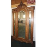 NV- A highly decorative carved mahogany French style armoire/wardrobe with a mirrored door and two