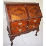 NV- a mahogany bureau with a fall front enclosing a fitted interior, two drawers below on cabriole