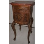 NV- A decorative French style bedside cabinet with a mottled marble top on cabriole legs