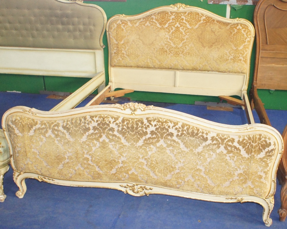 NV- A decorative white and gilt painted double bed with an upholstered head and foot