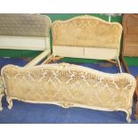 NV- A decorative white and gilt painted double bed with an upholstered head and foot