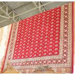 NV- a red ground Kashmir carpet, Bokhara design. Approx. 380 X 280cm