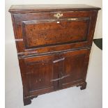 NV- an oak escritoire style bureau with a fall front enclosing fitted drawers and cupboards under