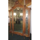 NV- A highly decorative carved mahogany French style armoire/wardrobe with a mirrored door and two