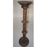 NV- A carved hardwood torchere with a twisted column