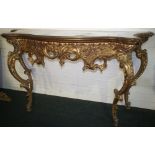 NV- A very decorative gilt work consul table with four shaped supports, a fretwork and foliate