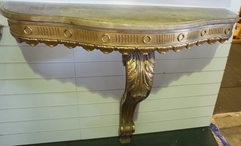 NV- A decorative gilt work consul table with one support and a mottled shaped marble top