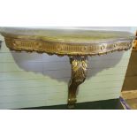 NV- A decorative gilt work consul table with one support and a mottled shaped marble top