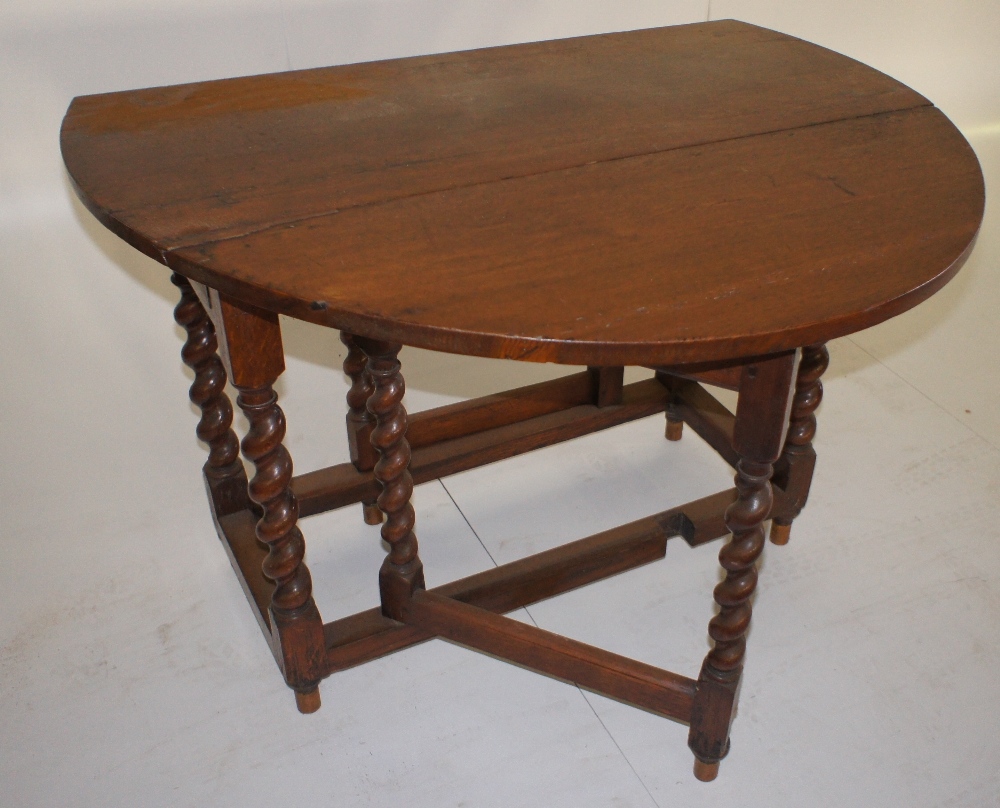 NV- A quality oak oval topped drop leaf gate legged table on twisted legs with one end drawer