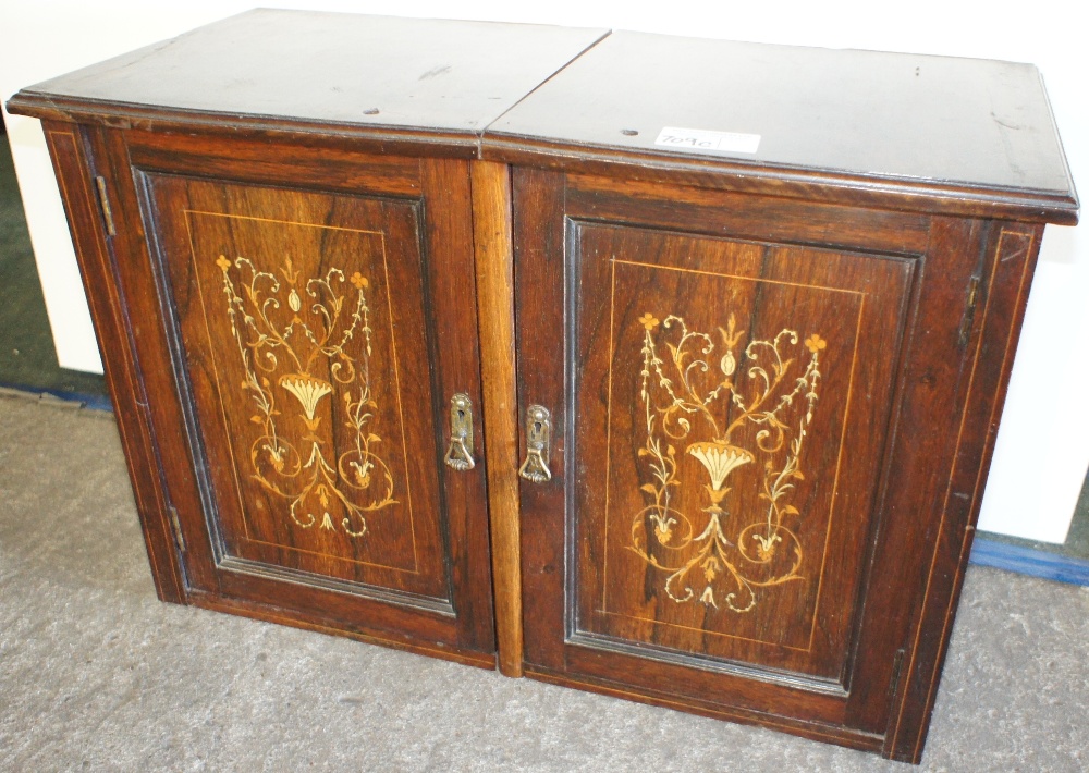 NV- A small wall cabinet with two marquetry inlaid rosewood doors