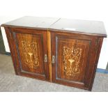 NV- A small wall cabinet with two marquetry inlaid rosewood doors