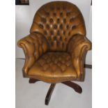 NV- An old gold coloured buttoned leather swivel office chair