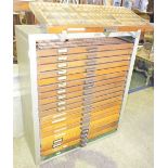 NV- 1 printer's cabinet containing 20 wooden single handle type storage drawers. The cabinet has two