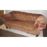 NV- a pink upholstered buttoned two seater chesterfield settee with a drop end