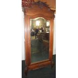 NV- A highly decorative carved mahogany French style armoire/wardrobe with a mirrored door