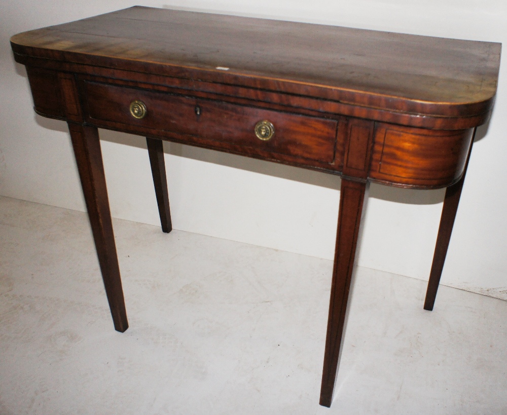 NV- an inlaid mahogany rectangular topped fold over tea table with one drawer on tapered legs