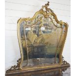 NV- A large decorative wall mirror with a gilt work frame of scroll work decoration