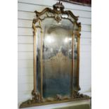 NV- A large decorative wall mirror with a gilt work frame of foliate and scroll work decoration