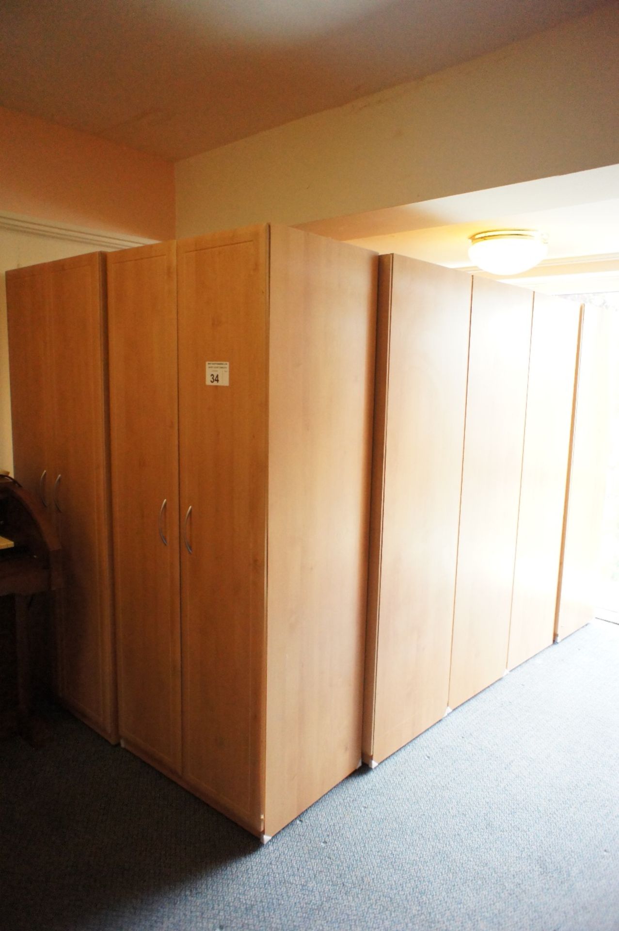 10 matching woodgrained finished two door single wardrobes (located in room 16, Davey Court)