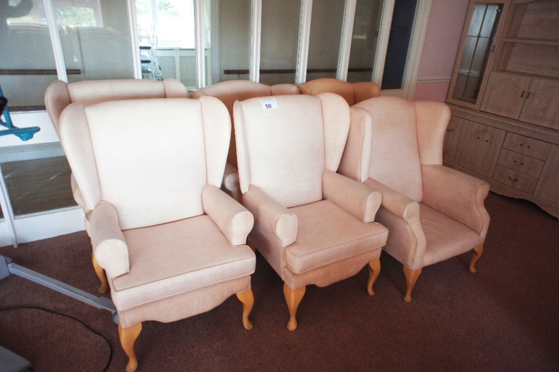 6 fawn easy clean upholstered winged armchairs (located in room 18, Davey Court)