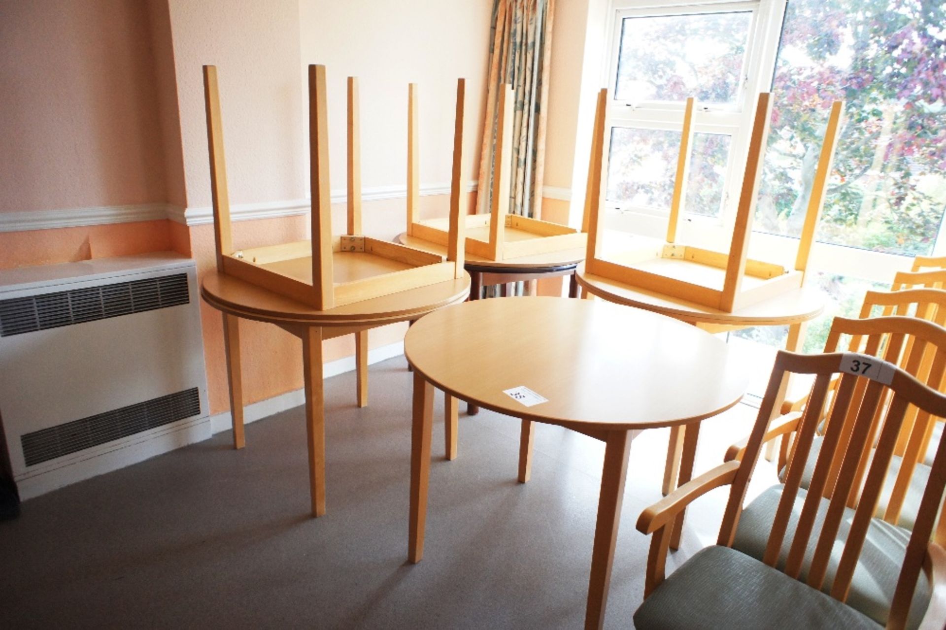 7 lightwood circular topped canteen tables (located in room 17, Davey Court)