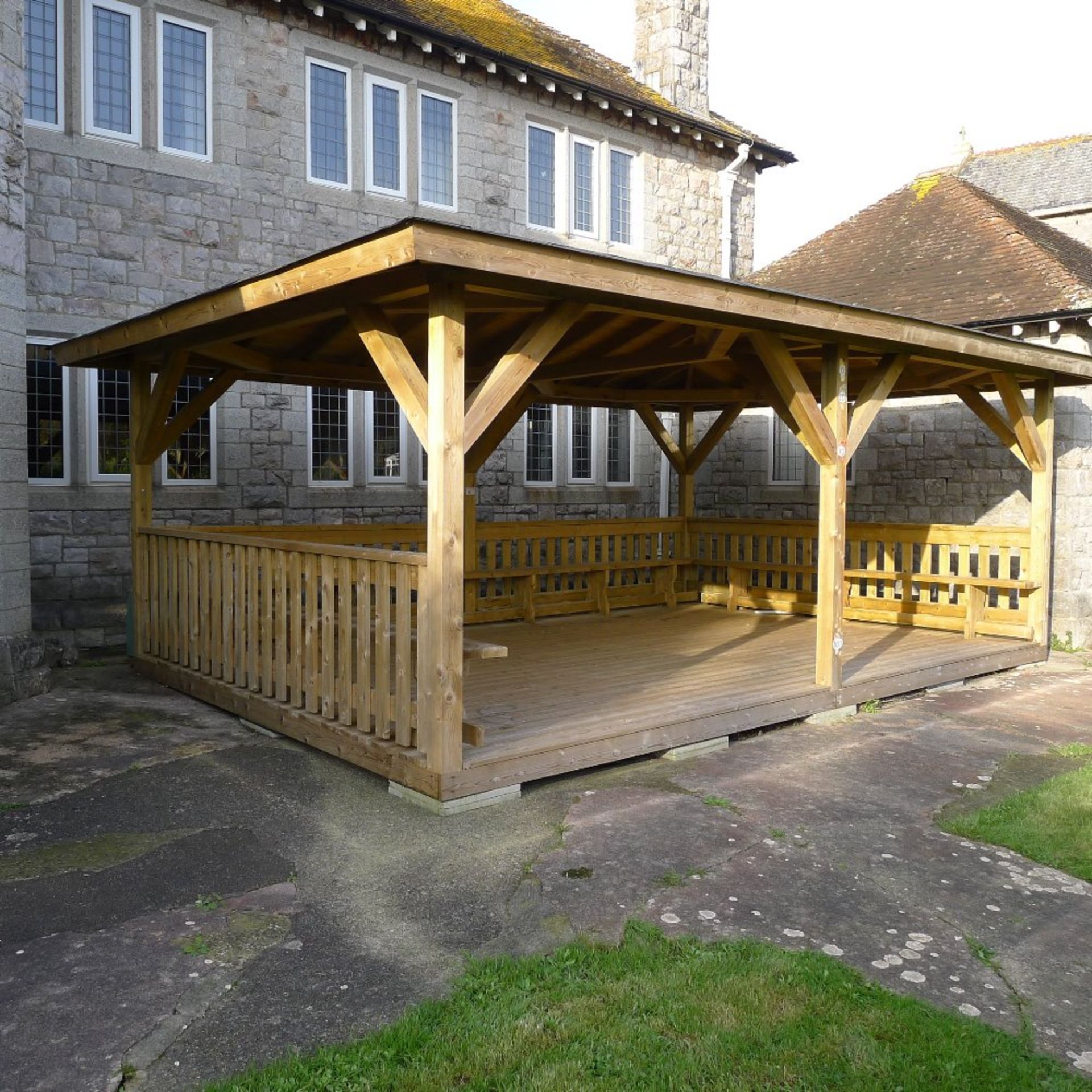 1 large free standing timber constructed outdoor play area with roof and seating, floor area 6m. X