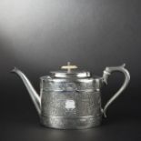 Oval silver-plated teapot with engraved decoration of ivy leaves and interlacings. Ivory finial