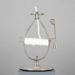 Silver wax-jack candlestick atop circular base. Side loop grasp. Snuffer terminating with scroll-