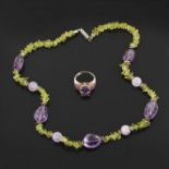 Small jewelry parure comprising: silver ring set with purple gemstones necklace with amethyst and