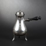 Plain silver-plated baluster tripod hot beverage pitcher. Button-shaped finial. Turned ebony side