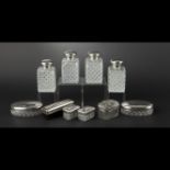 Plain silver and cut-glass toiletry set with diamond-points comprising four square perfume bottles