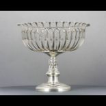 Circular pierced plated ware metal fruits tazza. Atop circular support surmounted with three busts