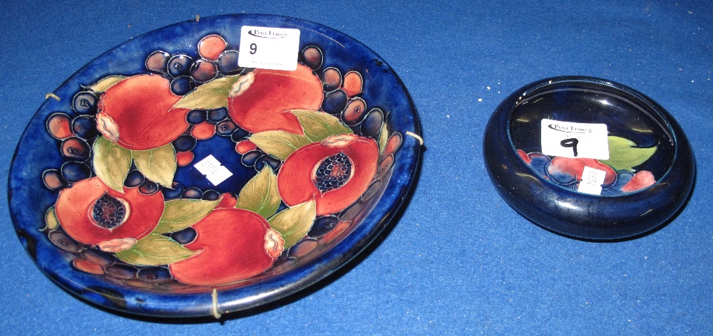 A Moorcroft art pottery tube lined pomegranate design dish with impressed and painted marks to