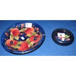 A Moorcroft art pottery tube lined pomegranate design dish with impressed and painted marks to