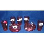 Group of assorted cranberry glass items