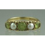 A 9CT GOLD PERIDOT AND SEED PEARL RING s