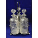 Matched set of three wheel engraved floral decorated slice and star cut bottle shaped decanters with