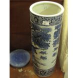 Oriental blue and white cylindrical porcelain stick stand with wooden cover.