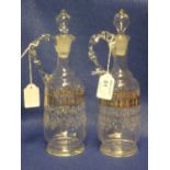 Pair of late Victorian clear glass, enamel decorated ewers with blown stoppers and loop handles.