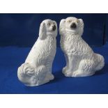 Pair of 19th Century Staffordshire pottery, white over-gilded, seated spaniels with black and tan