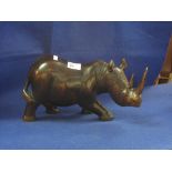 Large carved wooden study of a rhinoceros.