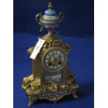 19th Century French gilt spelter, porcelain mounted, two train architectural mantle clock with urn