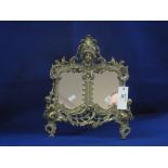Rococco style brass cherub mounted mirror or double photograph frame.